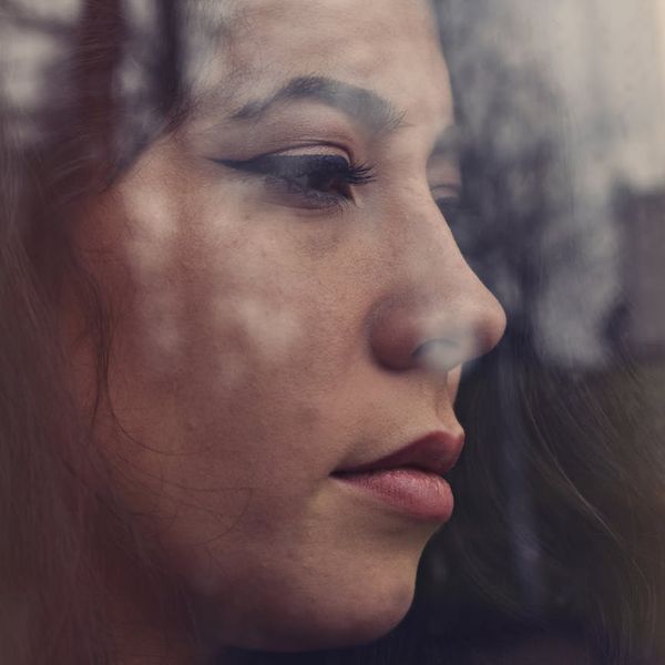 Profile of a calm woman meditating with her eyes closed.